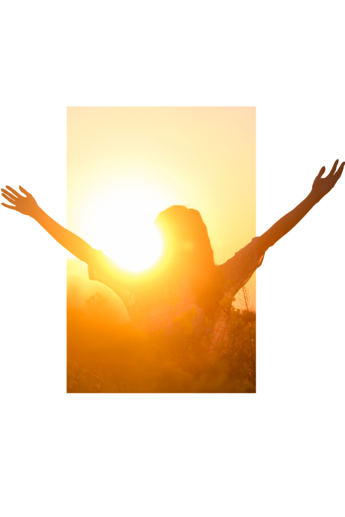 Person standing in a sunlit field with arms raised, embracing freedom and recovery from fentanyl addiction.