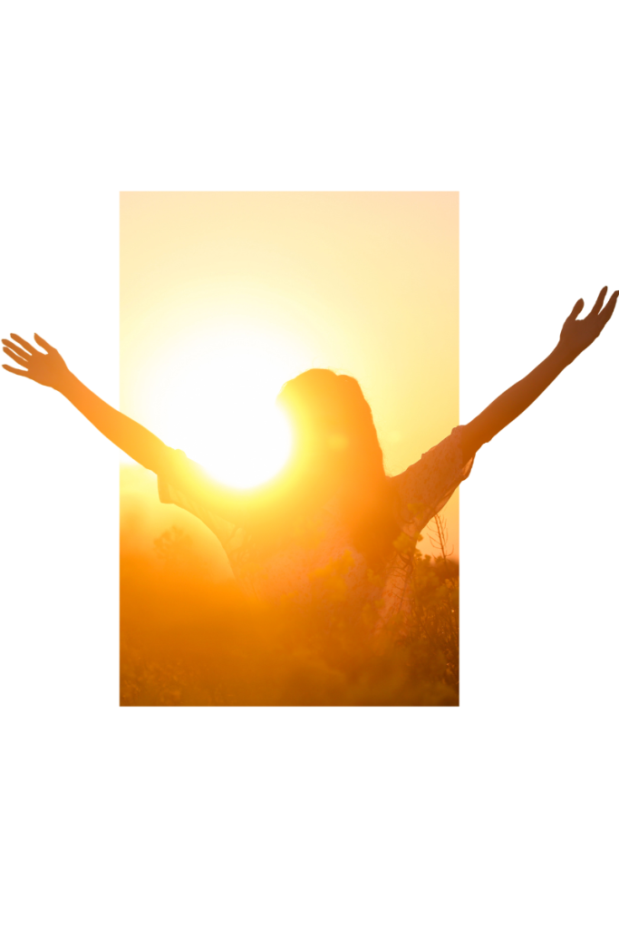 Person standing in a sunlit field with arms raised, embracing freedom and recovery from benzodiazepine addiction.